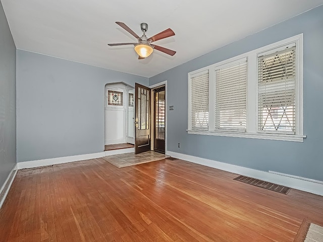 empty room featuring hardwood / wood-style flooring and ceiling fan