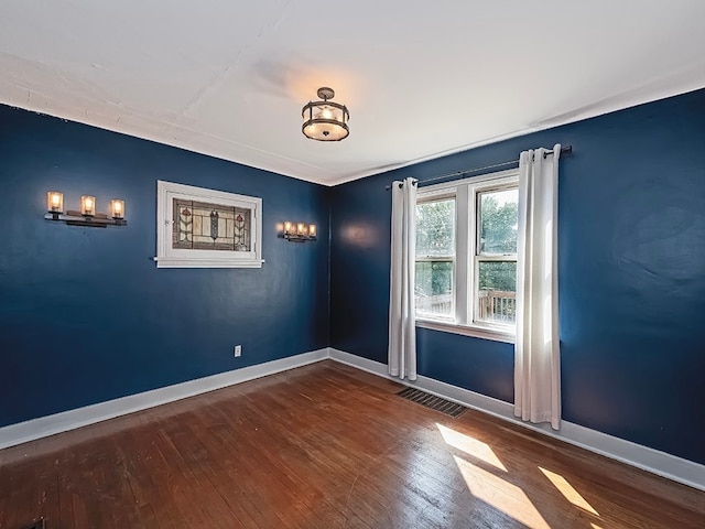 empty room with hardwood / wood-style flooring