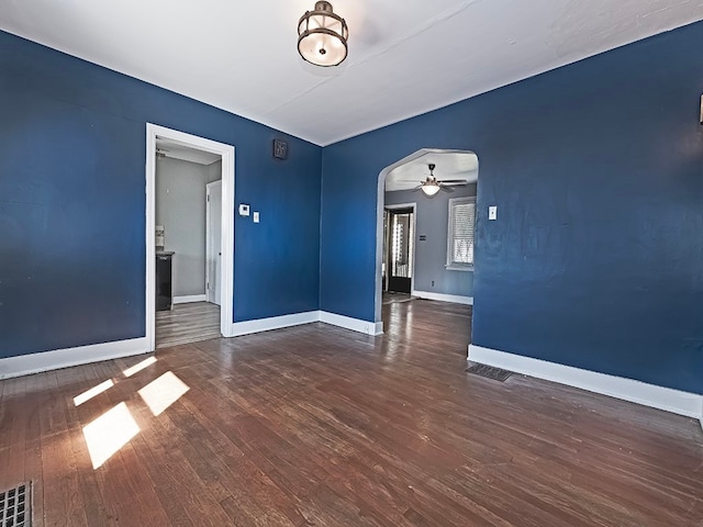 unfurnished room featuring dark hardwood / wood-style floors and ceiling fan