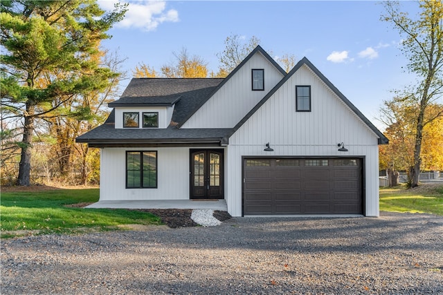 modern inspired farmhouse featuring a front lawn and a garage