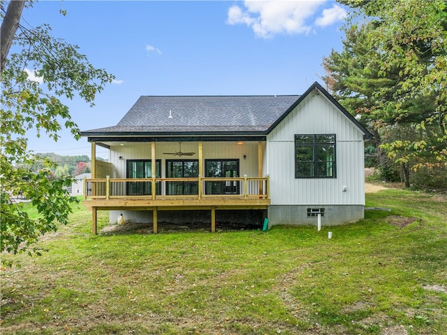 rear view of property with a yard and ceiling fan