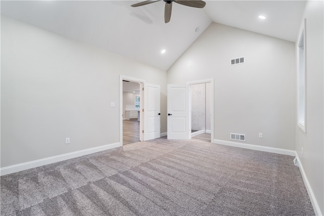 unfurnished bedroom with ceiling fan, multiple windows, high vaulted ceiling, and carpet floors