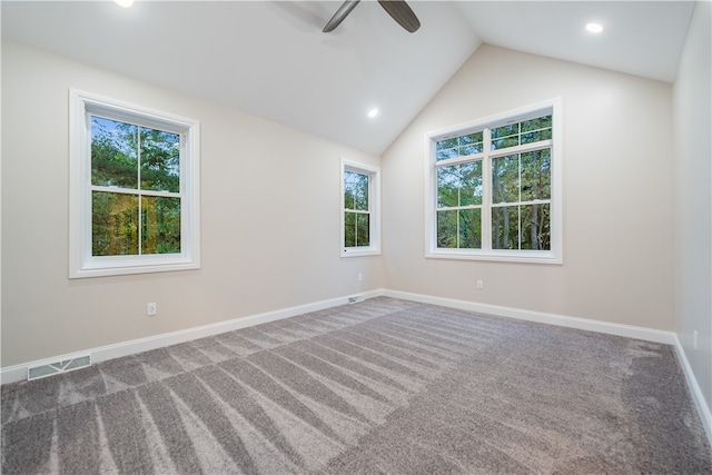 carpeted spare room with lofted ceiling and ceiling fan