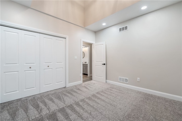 unfurnished bedroom with a closet and carpet floors