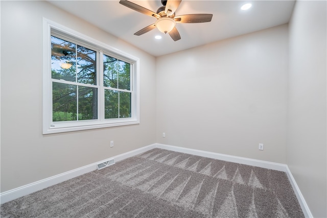 spare room featuring ceiling fan and carpet