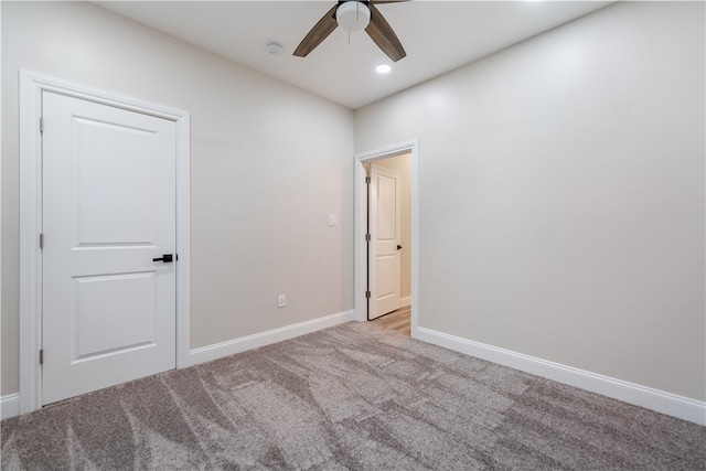 carpeted empty room featuring ceiling fan