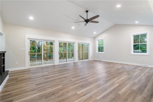 unfurnished living room featuring ceiling fan, vaulted ceiling, and light hardwood / wood-style floors