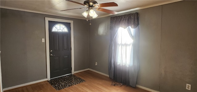 foyer with ornamental molding, light hardwood / wood-style floors, and ceiling fan