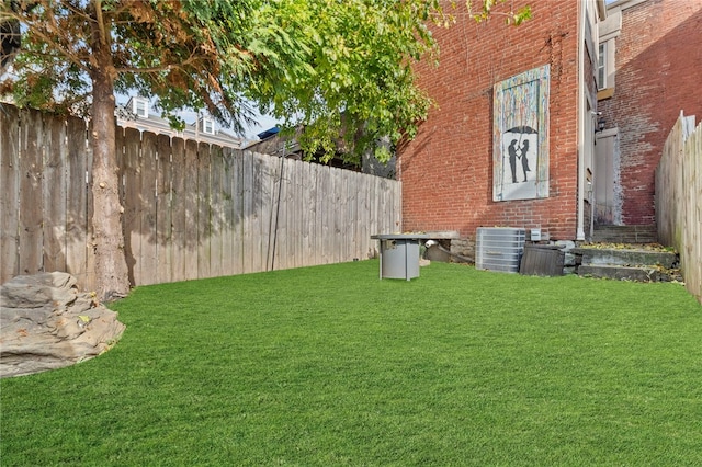 view of yard with central air condition unit