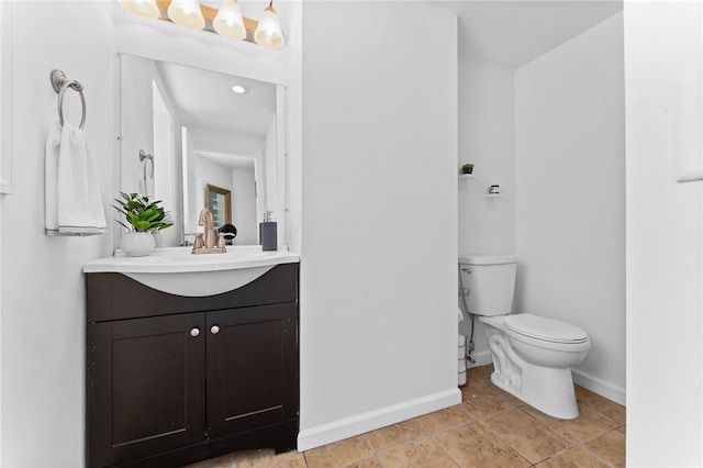 bathroom with tile patterned flooring, vanity, and toilet