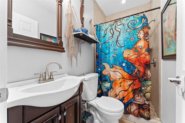 bathroom featuring toilet, vanity, a shower with shower curtain, and tile patterned floors