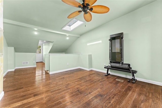 bonus room featuring ceiling fan, vaulted ceiling with skylight, and dark hardwood / wood-style floors