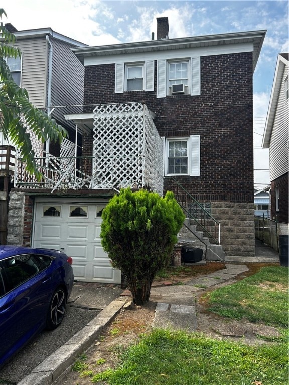 view of front of property featuring a garage and cooling unit