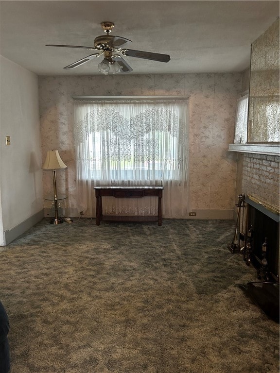 interior space with a fireplace, ceiling fan, and plenty of natural light