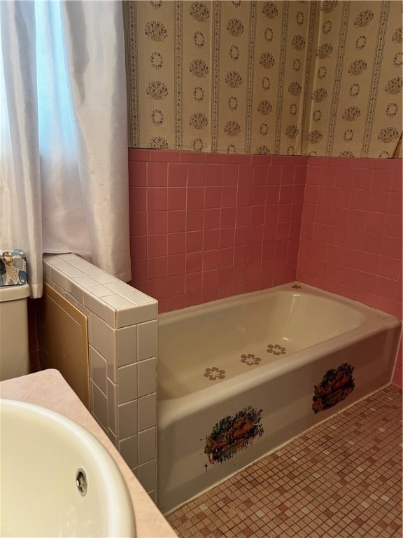 bathroom with a washtub and sink