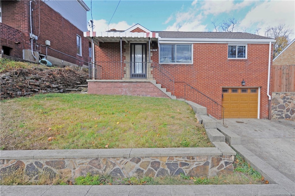 view of front of home with a front lawn and a garage