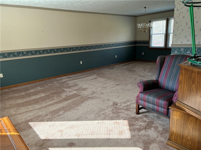 sitting room with ornamental molding, carpet, a textured ceiling, and an inviting chandelier