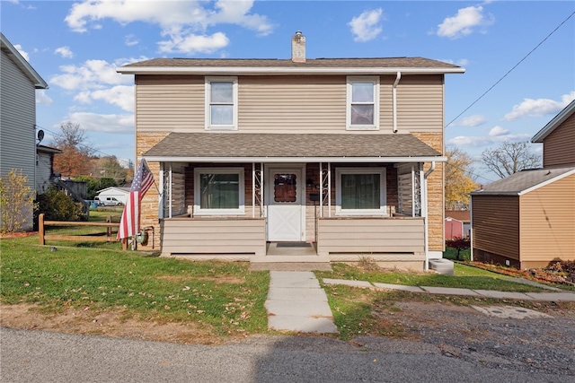 view of property featuring a front lawn