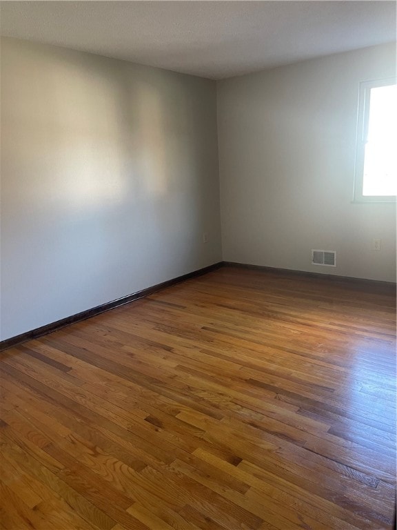 empty room with dark wood-type flooring