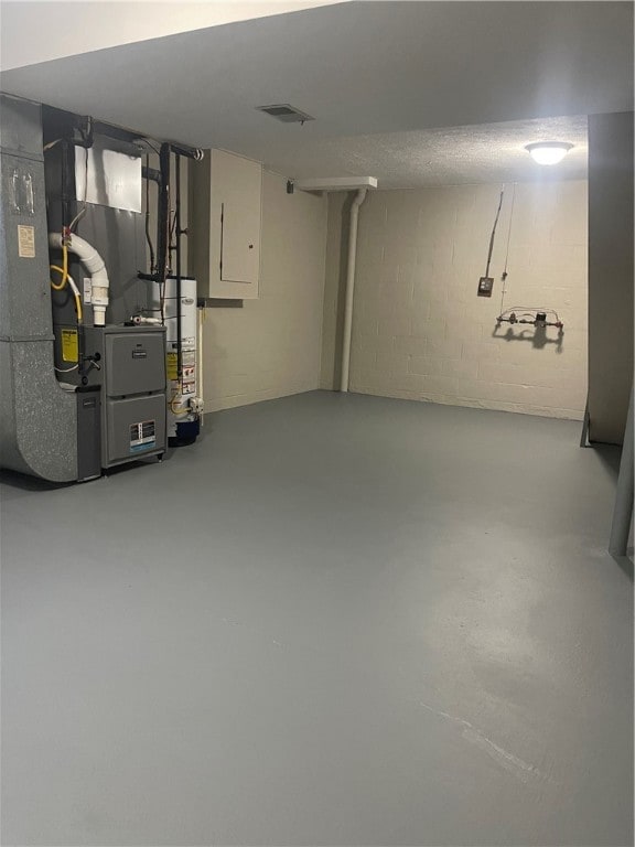 basement featuring water heater and heating unit