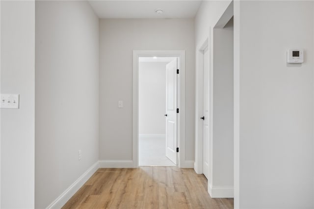 hallway with light hardwood / wood-style floors