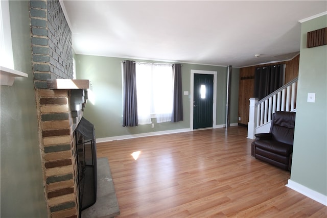 unfurnished living room featuring a fireplace and light hardwood / wood-style floors