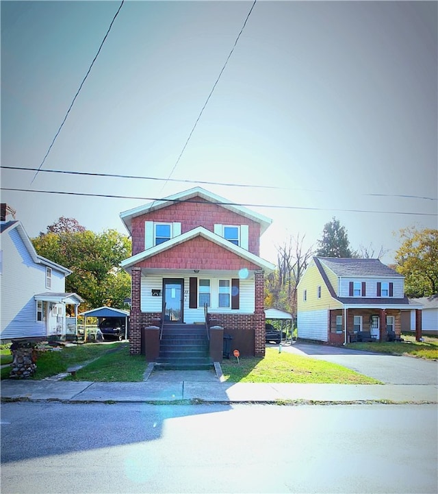 view of front of home with a front yard and a porch