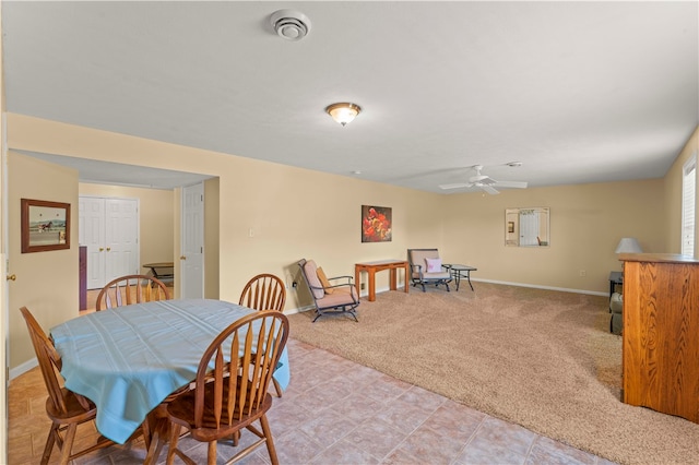 carpeted dining area featuring ceiling fan