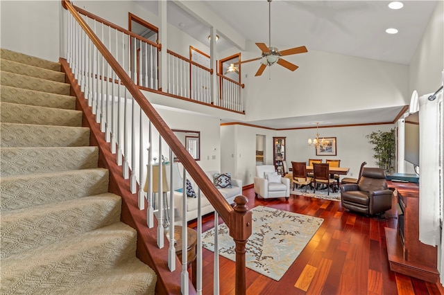 stairs featuring high vaulted ceiling, beamed ceiling, hardwood / wood-style flooring, and ceiling fan with notable chandelier