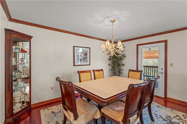 dining room featuring an inviting chandelier, hardwood / wood-style flooring, and crown molding