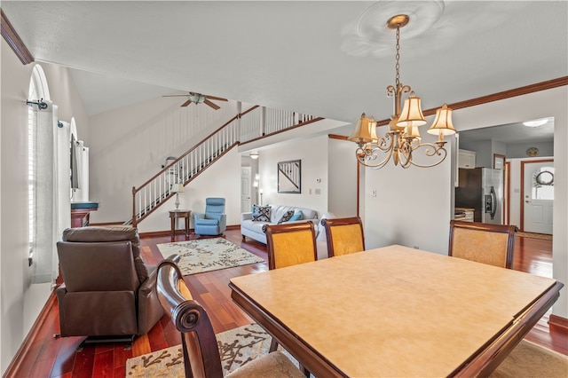 dining area featuring ceiling fan with notable chandelier, crown molding, and dark hardwood / wood-style flooring