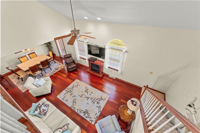 living room featuring ceiling fan, dark hardwood / wood-style floors, and high vaulted ceiling