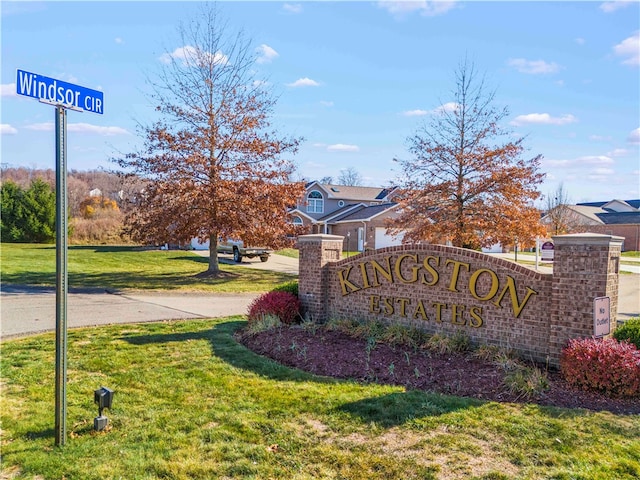 community / neighborhood sign with a lawn