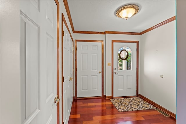 entryway with wood-type flooring, a textured ceiling, and ornamental molding