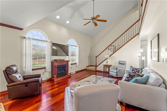 living room featuring hardwood / wood-style flooring, ceiling fan, a textured ceiling, and high vaulted ceiling