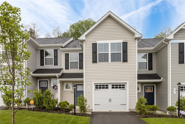 view of front of home with a garage and a front lawn