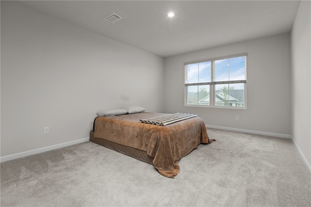 bedroom featuring light carpet