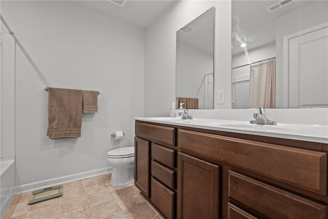 bathroom with tile patterned flooring, vanity, and toilet