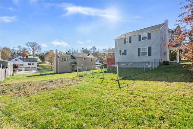 back of house with a lawn