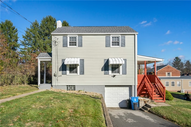 view of front of property with a garage and a front lawn