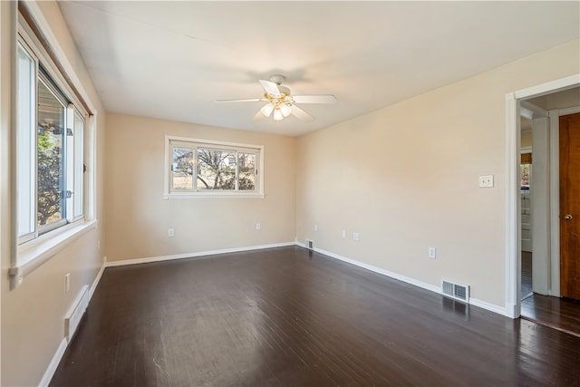 unfurnished room with dark wood-type flooring and ceiling fan