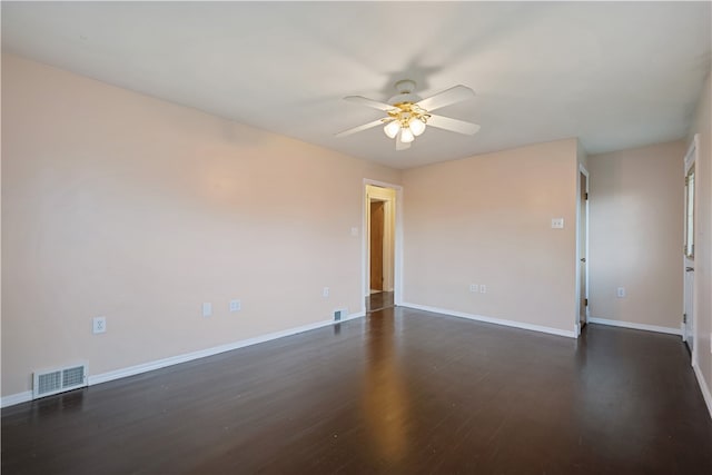 empty room with ceiling fan and dark hardwood / wood-style floors