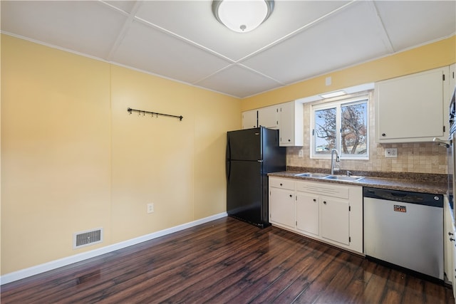 kitchen with stainless steel dishwasher, black refrigerator, white cabinets, and sink