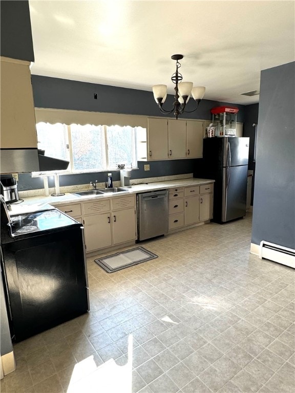 kitchen featuring stainless steel appliances, hanging light fixtures, an inviting chandelier, baseboard heating, and cream cabinetry