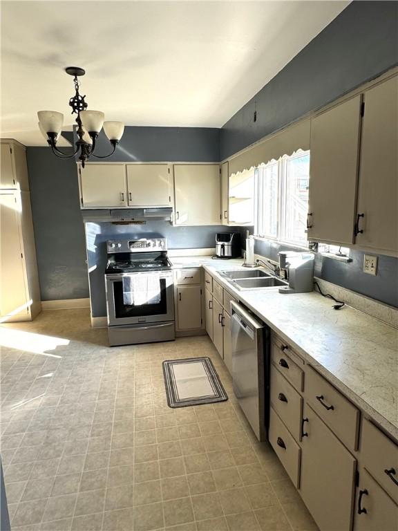 1300 Sycamore St, Connellsville, PA 15425 - kitchen with stainless steel appliances, a chandelier, decorative light fixtures, and under cabinet range hood