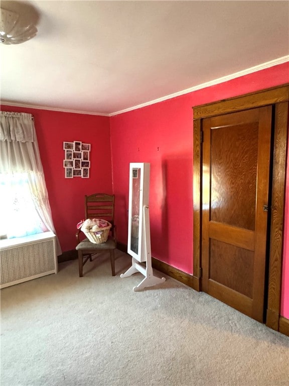 unfurnished bedroom featuring radiator heating unit, carpet flooring, and ornamental molding