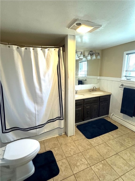 bathroom featuring toilet, vanity, and tile patterned floors