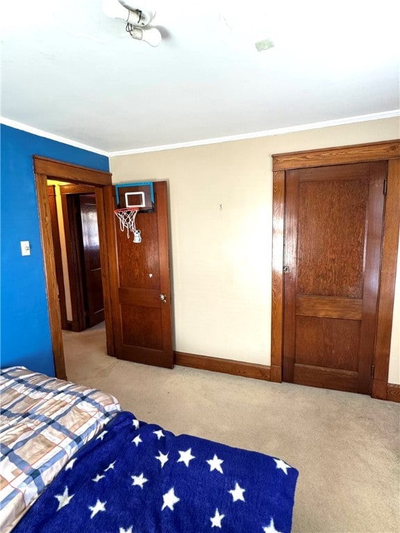 unfurnished bedroom with ornamental molding and light colored carpet