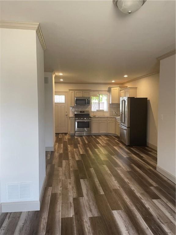 kitchen featuring backsplash, crown molding, stainless steel appliances, and dark hardwood / wood-style floors