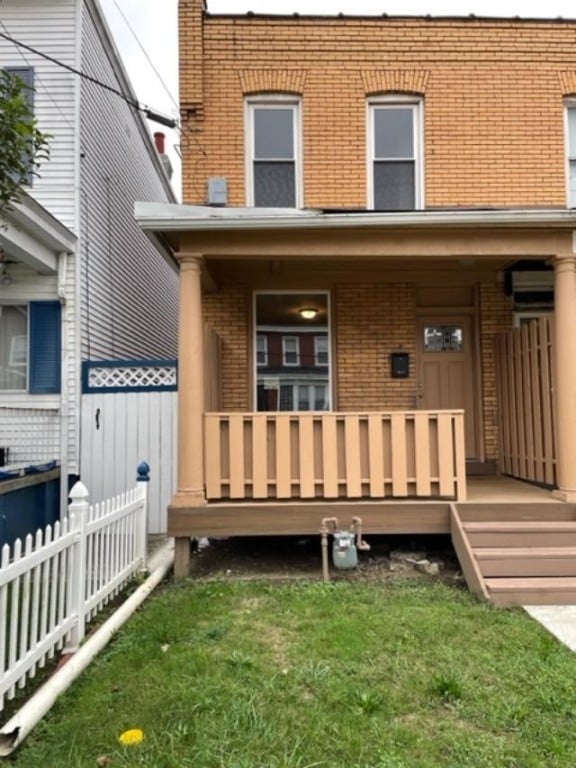 back of house featuring covered porch